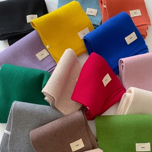 Elegant solid color knitted winter scarves in various vibrant tones with minimalist emo label