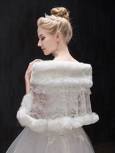Detail showing the layered white faux fur and floral lace texture of the bridal shawl
