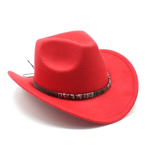 Detail of red wool cowboy hat with vintage gear metal accessories and leather band