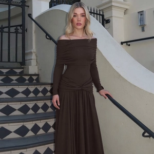 Detail view of deep brown off-shoulder pleated maxi dress with long sleeves and smocked waist