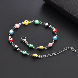 Close-up of colorful enamel evil eye beads on a stainless steel chain with lobster clasp
