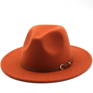 Detail showing bright orange wool fedora with a brown leather strap and gold buckle