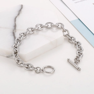 Detail of silver stainless steel chain bracelet with a polished finish and OT toggle clasp