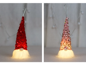 Detail of red and pink sequin Christmas gnomes with warm LED lights and faux fur beards