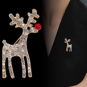 Exquisite gold reindeer brooch with sparkling rhinestones and a red nose on a black blazer