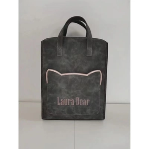 Detail of dark grey laptop backpack featuring a cat ear pocket and Laura Bear branding