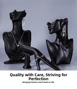 Matte black resin bust and hand display showcasing silver necklaces and gold bracelets