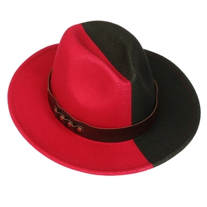 Macro shot of a two-tone red and black wool felt fedora with a leather band and metal rivets