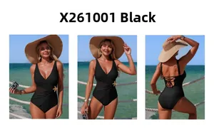 Detail view of black one-piece swimsuit with mesh panels and gold starfish accessories