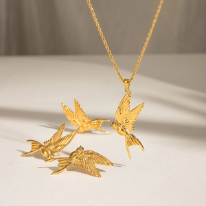 Golden peace dove jewelry set with minimalist bird pendant necklace and stud earrings