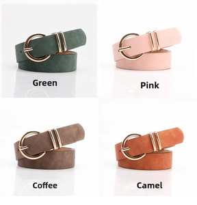 Detail view of nubuck leather belts in green, pink, brown, and camel with gold buckles