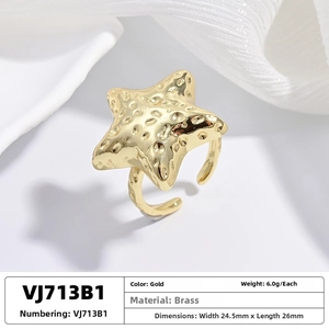 Detailed close-up of golden brass starfish ring featuring unique hammered texture finish
