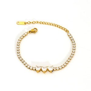 Detail of gold tennis bracelet with heart-shaped cubic zirconia and adjustable extender