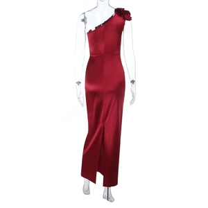 Détail macro de la robe en satin rouge avec fleur 3D et fente au dos de la jupe