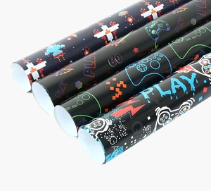Macro detail of four rolls of gaming themed wrapping paper with colorful controller patterns