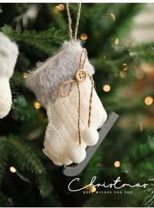 Detail of knit Christmas mini stocking ornament with plush trim and wooden button