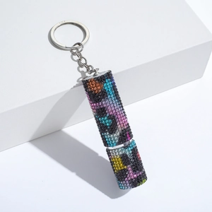 Macro view of leopard print rhinestone perfume bottle keychain with crystal details