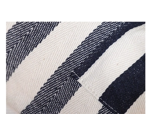 Macro shot of striped canvas handbag fabric with high-quality herringbone weave and stitching