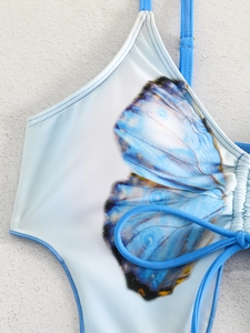 Close-up of blue butterfly print bikini fabric with side ruching and delicate straps