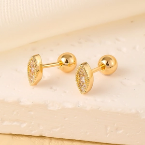 Detail of gold marquise zircon ear studs with secure screw ball back closure on silk