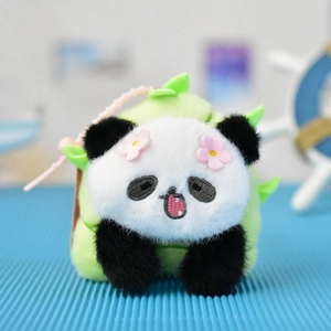 Close-up detail of a cute panda plush charm nestled inside a green bamboo shoot sleeve