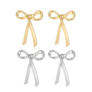 Detail showing bow pendant earrings in gold and silver finish on a clean white background