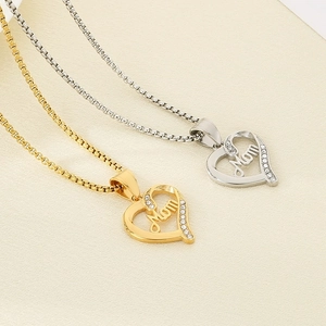 Close-up of gold and silver heart Mom pendants with sparkling small rhinestones