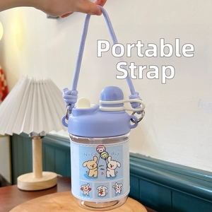 Detail of blue portable water bottle with cute cartoon dog sleeve and purple woven strap