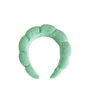 Mint green braided spa headband made of soft terry cloth for skincare and washing face
