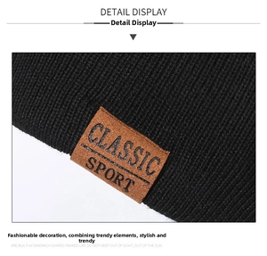 Close-up of black ribbed knit beanie featuring a brown leather Classic Sport patch