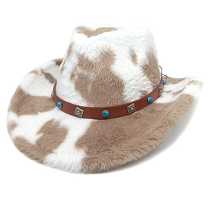 Detail of cow print cowboy hat with turquoise and silver studs on a leather band