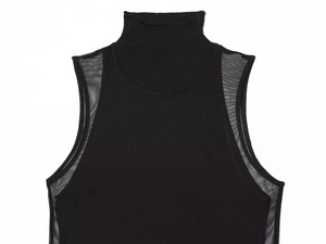 Detail view of black sleeveless high-neck top featuring sheer mesh patchwork and knit texture
