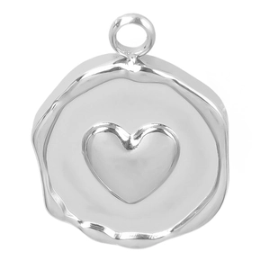 Detailed macro view of irregular silver stainless steel pendant with textured heart motif