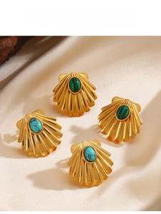 Detailed view of scallop-shaped gold stud earrings with malachite and turquoise stones