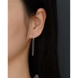 Close-up of S925 silver long tassel chain earrings with three sparkling zircons on model