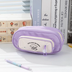 Detail of multi-layer pencil case with cute dog illustration and purple zipper puller