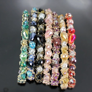 Colorful handmade crystal beaded hair clips in various vibrant colors on black mirror
