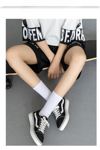 Breathable white mid-calf cotton crew socks shown in a lifestyle skateboarding scene