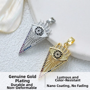 Macro shot of gold and silver evil eye pendants with sparkling zircons on marble
