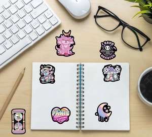 Pastel Goth stickers set featuring pink Cerberus and zombie bear on a desk setup