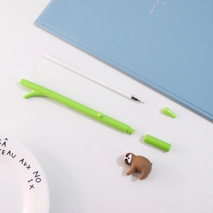 Creative green sloth branch gel pen with replaceable refill on a minimalist desk setup