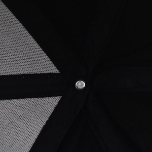 Detail view showing black canvas panels, grey mesh lining and metal rivet inside the cap