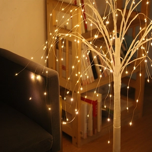 Close-up of LED birch tree light branches with warm glowing beads for cozy home decor