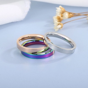 Close-up of 3mm stainless steel rings in silver, rose gold, and rainbow mirror finishes