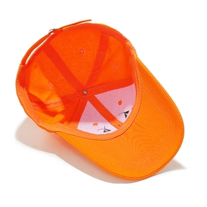 Detail view of the orange cotton baseball cap interior with stitching and lining