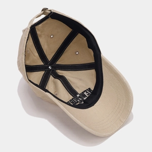 Detailed interior stitching and structure of the khaki washed canvas baseball cap