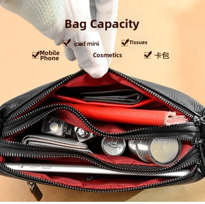 Internal view of black leather bag showing multiple compartments and storage capacity