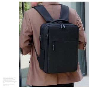 Business commuter backpack in black matte finish with built-in USB port for charging