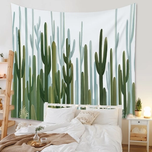 Detail of bohemian cactus tapestry hanging over a bed in a cozy bedroom setting