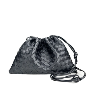 Elegant black woven leather crossbody bag with drawstring closure and slim shoulder strap